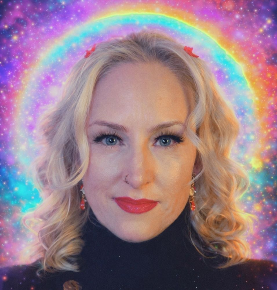 Blonde woman with curly hair and red lipstick in front of a colorful cosmic background.