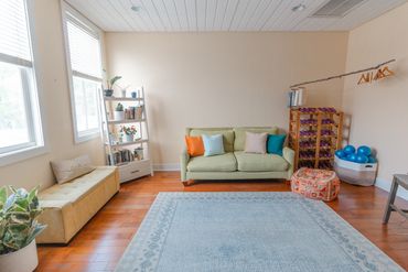 Bright, cozy living room with large windows.