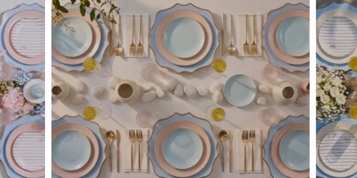 Elegant table setting with pastel plates and golden cutlery.