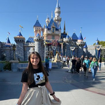 Liz in a Mickey dress in front of Sleeping Beauty Castle