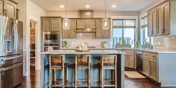 Modern kitchen with wooden cabinets and island seating.