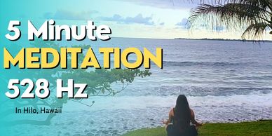Person meditating by the ocean in Hilo, Hawaii.