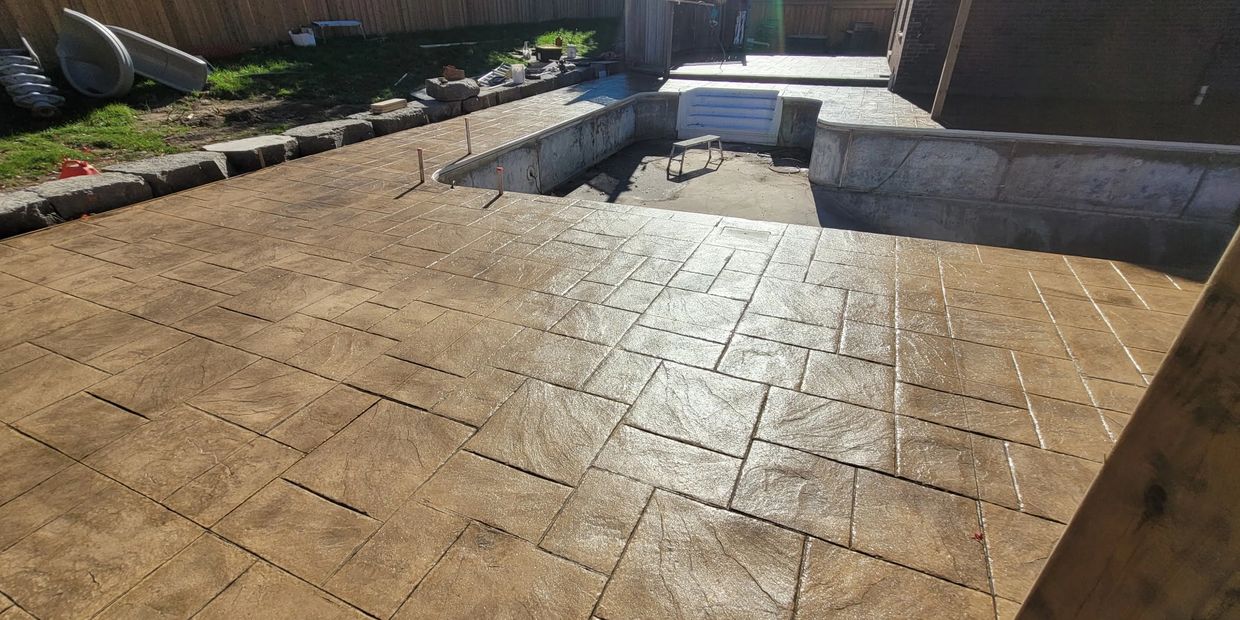 Stamped concrete pool deck and patio in natural beige. 
