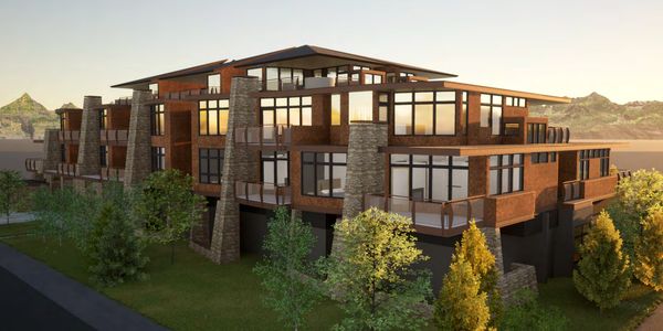 Modern multi-story building with large windows at sunset.