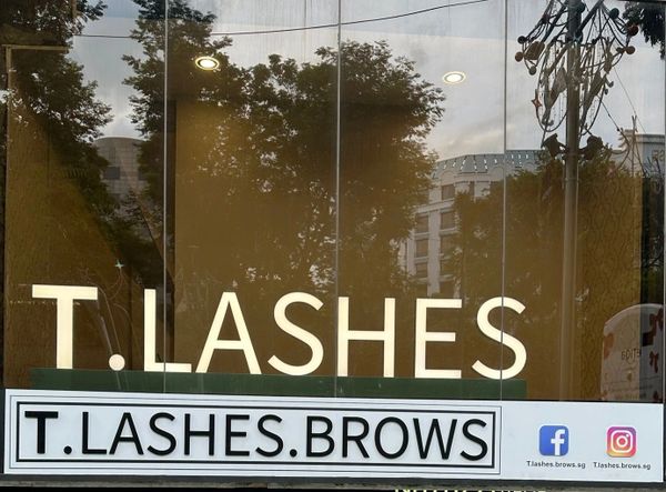 Storefront sign for T.Lashes, offering lashes and brows services.