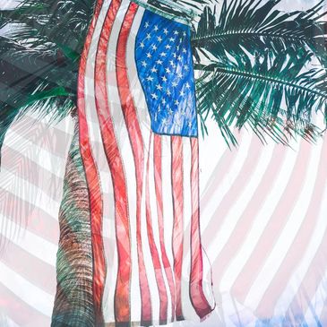American flag displayed among palm trees in Florida