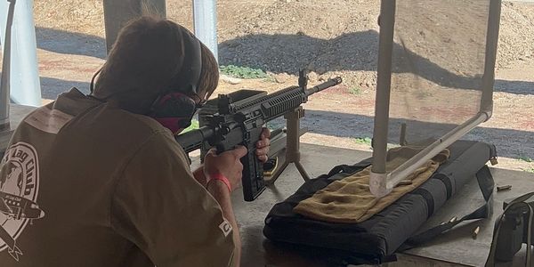 Man firing AR-15 , Colt m4 at range 