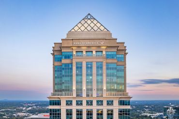 The Bank of America building with a pyramid-shaped top at sunrise.