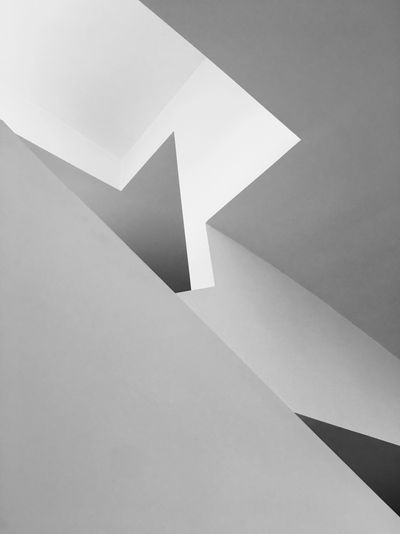 Abstract geometric shapes formed by light and shadows on walls.