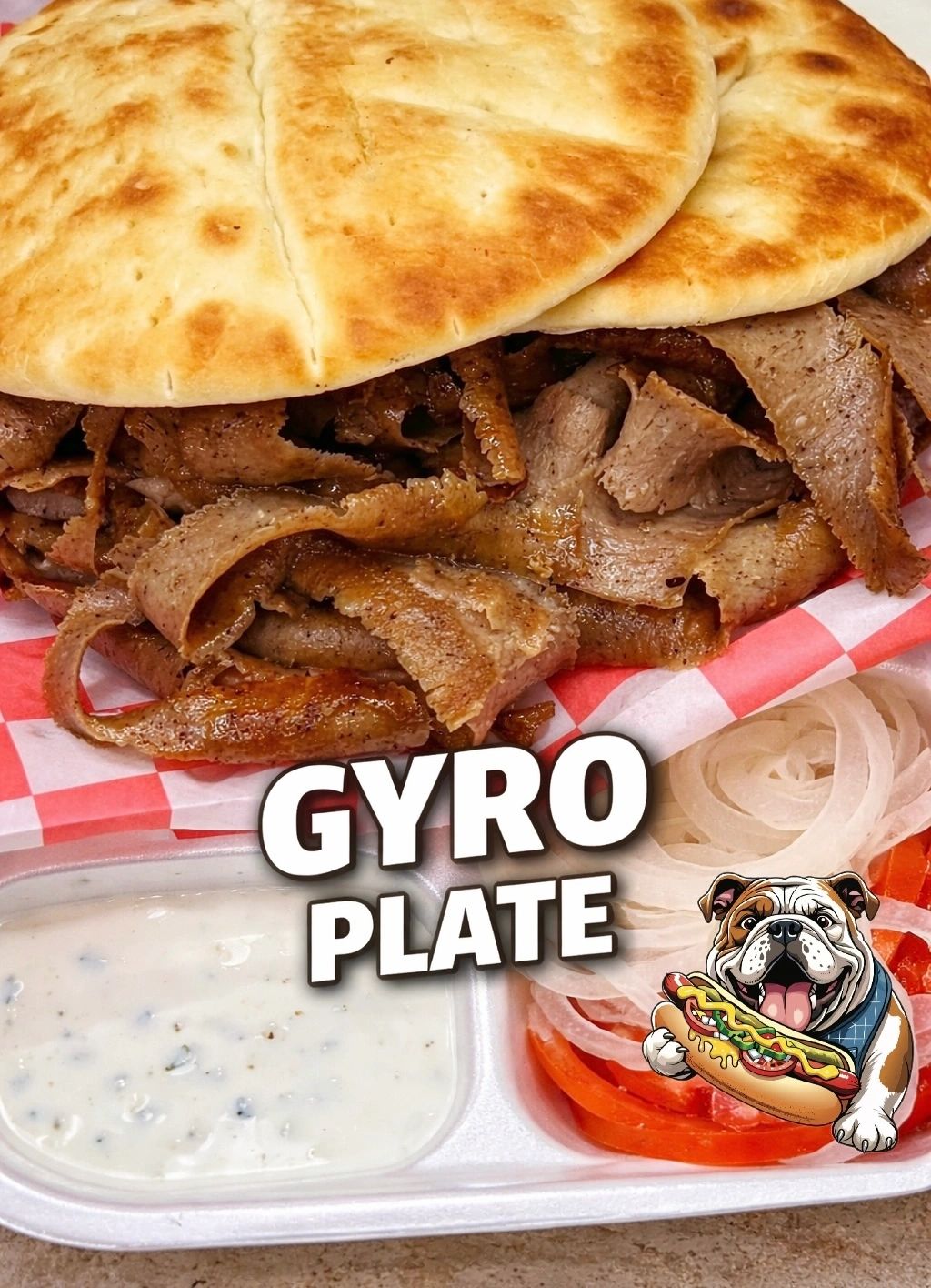 Close-up of a gyro plate with pita, sliced meat, tzatziki sauce, onions, and tomatoes.