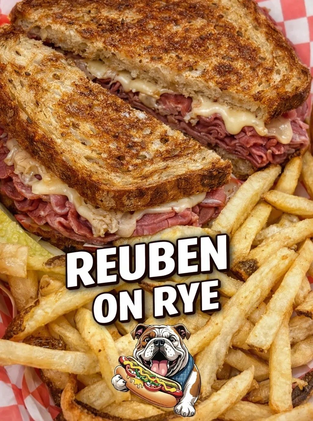 Close-up of a Reuben sandwich on rye with fries.