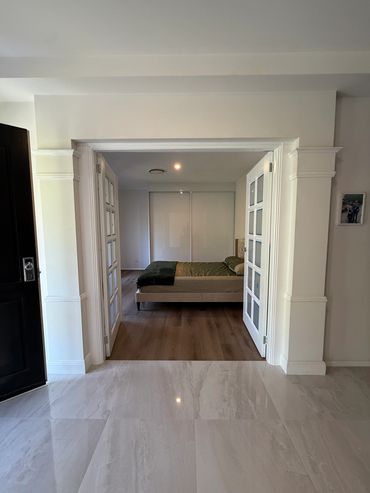 View of a bedroom through open French doors.