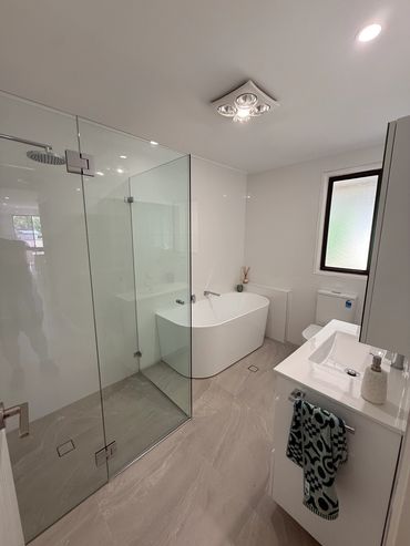 Modern bathroom with bathtub, shower, and sink.