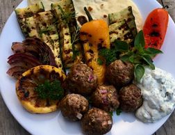 Greek Meatballs made with fresh herbs and spices, served with grilled vegetables.