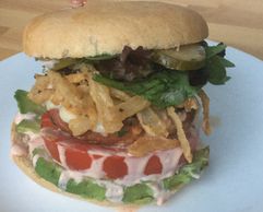 California Turkey Burger with crispy fried onions, homemade pickles, lettuce, tomato, and avocado.