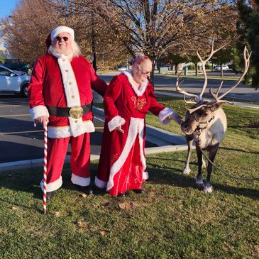 Santa & Mrs. Claus are feeding Holly. 