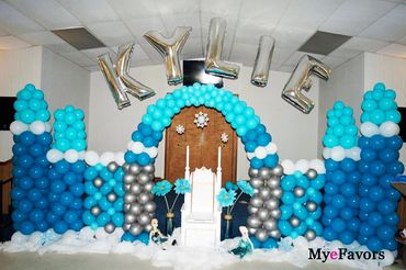 A blue and silver balloon castle with silver letter balloons spelling KYLIE.