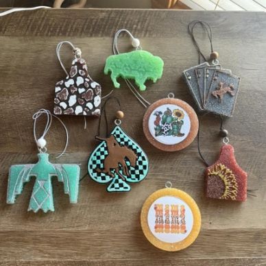Handmade felt ornaments with western and nature themes.