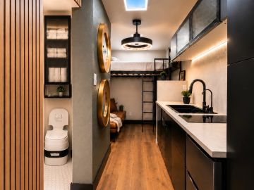 Modern compact living space with kitchen and sleeping area.