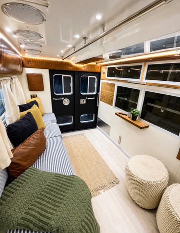Cozy interior of a camper van with seating and storage.