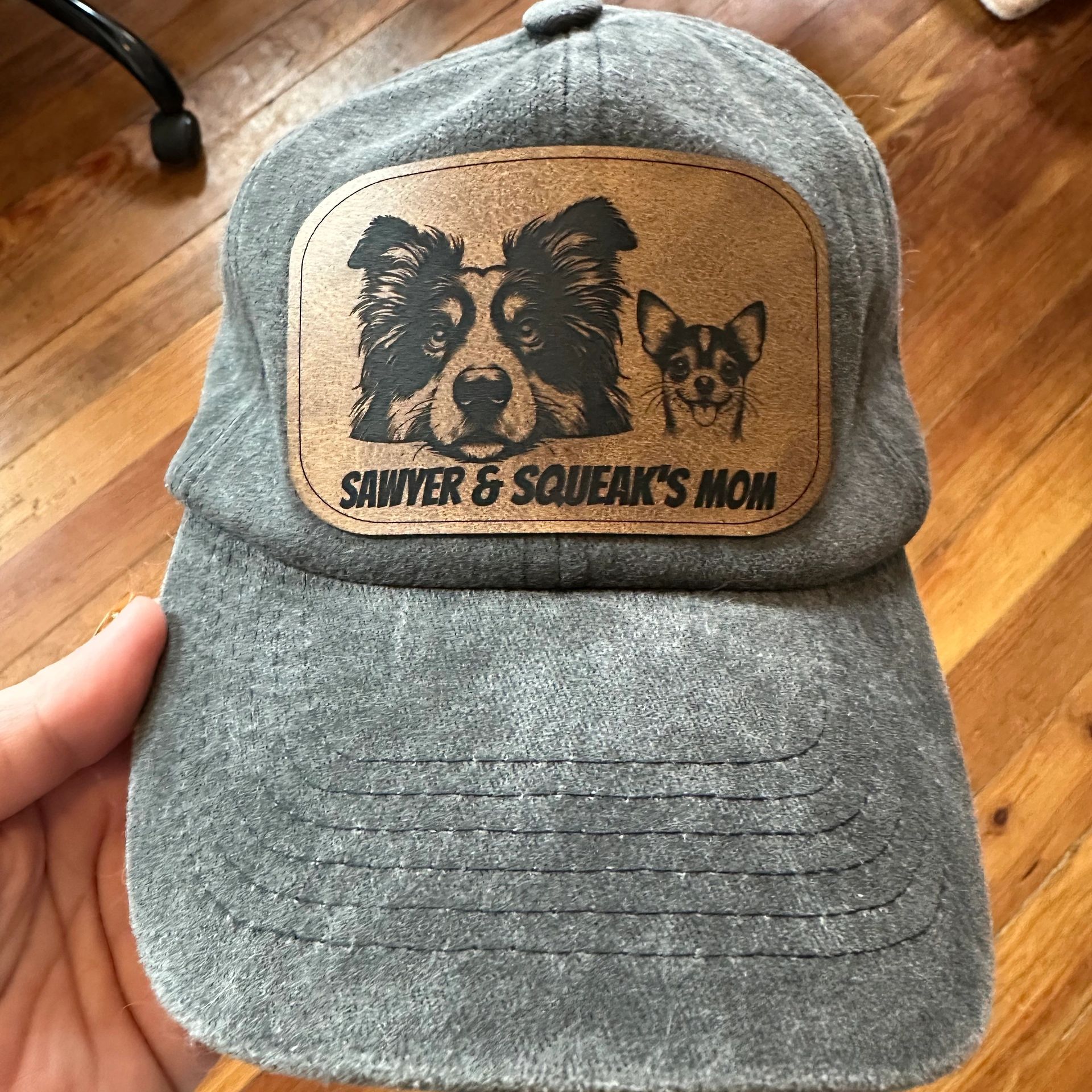 Gray cap with dog illustrations and text.