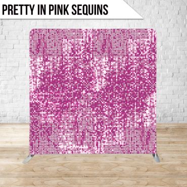 Pink sequin backdrop against white brick wall.