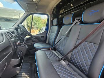 Inside view of a vehicle with leather seats and seat belts.
