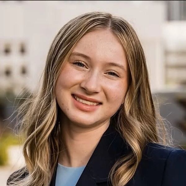 Young woman with blonde hair smiling.