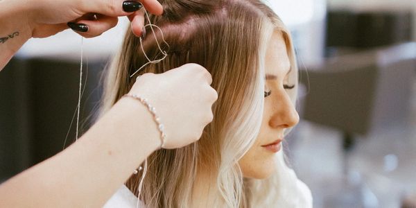 Taylor demoing her luxury hair extension services.