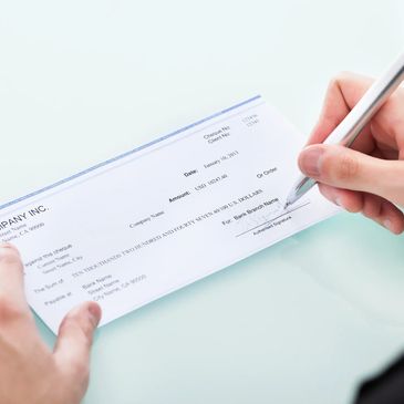 Person writing a check. 