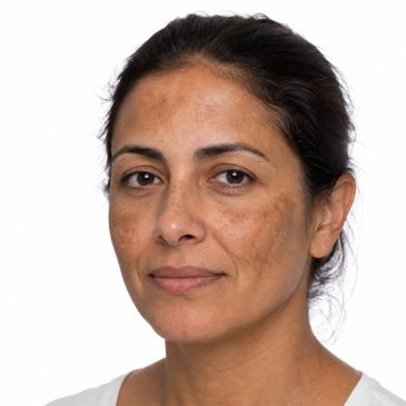 Close-up of a woman with natural skin tone and sunspots.