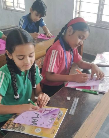Children doing art and craft activities in classroom.