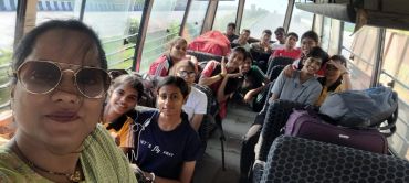 Group selfie of friends on a bus trip.