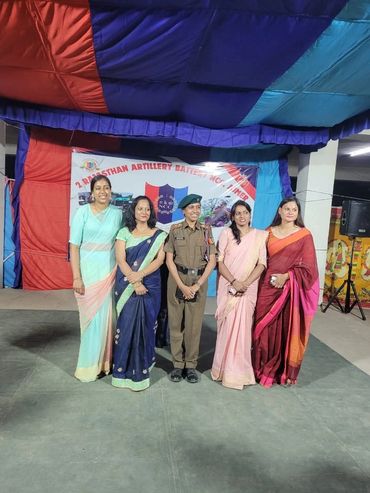 Group photo of women with one in military uniform.