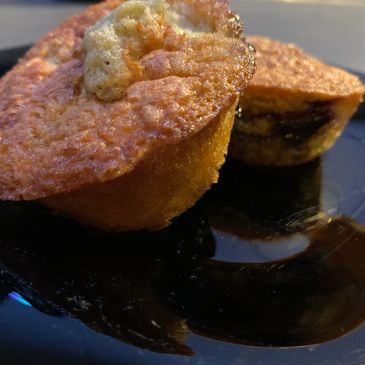 2 blueberry muffins on a black plate