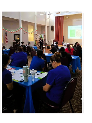 A group attending a presentation in a decorated meeting room.