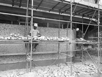 Milliner Construction stone workers installing the stone cladding