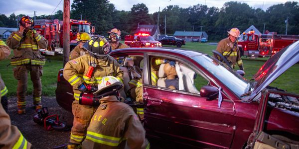 Firefighters attend to a simulated car crash rescue.