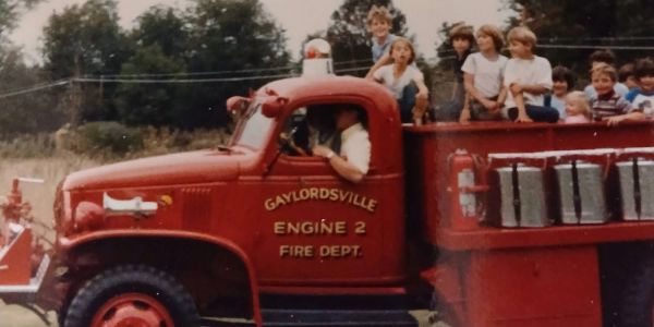 Children riding on a red fire truck from Gaylordsville Fire Department.