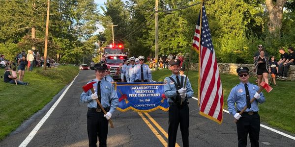 Fire department members march in a parade.