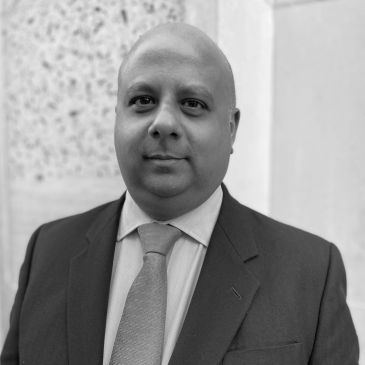 Portrait of a man in a suit and tie.