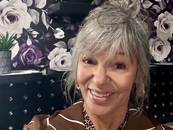 Smiling older woman with gray hair.