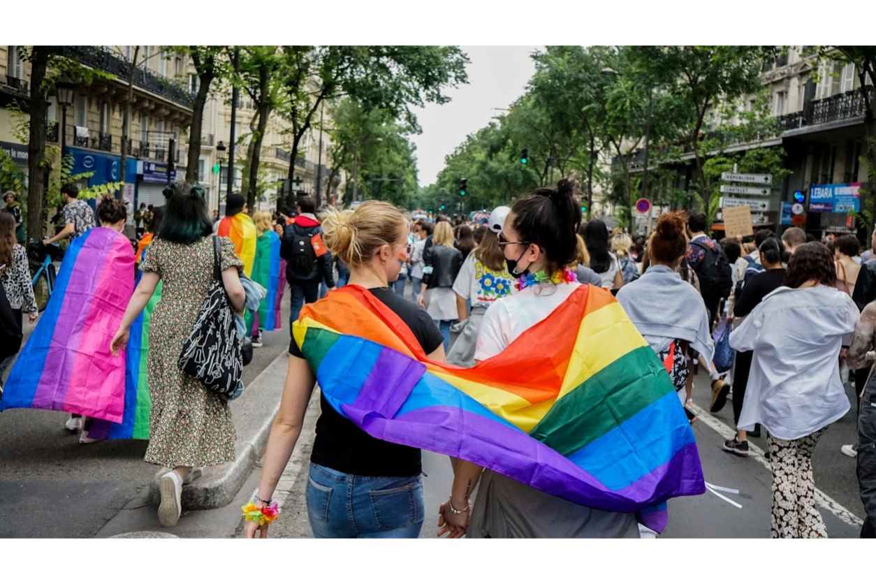 Lesbian couple walking in Pride parade. They are in affirming therapy at Restoring Balance Therapy. 