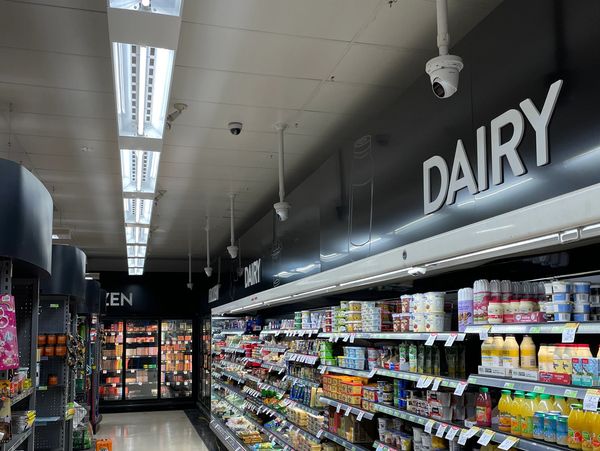 Security cameras installed from ceiling in supermarket