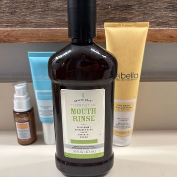 Bottle of Breath Away Essential Oil Mouth Rinse with skincare products.