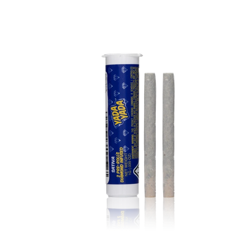 Blue tube container labeled Yada Yada with two rolled pre-rolled cones beside it.
