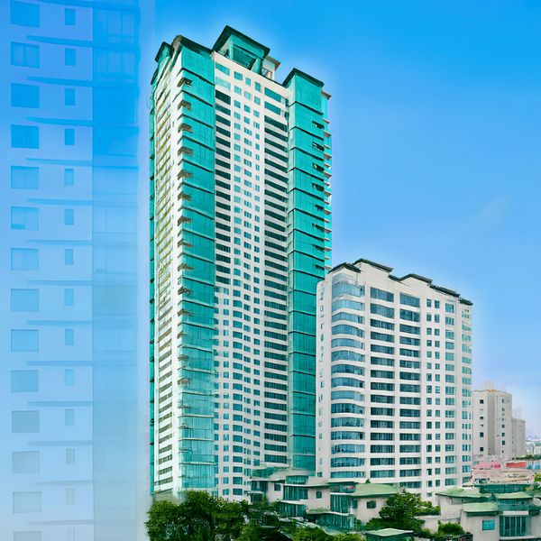 Modern tall buildings under clear blue sky.