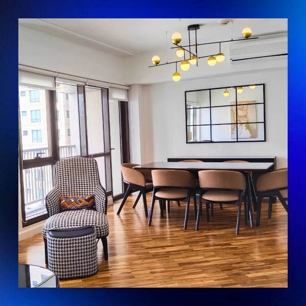 Modern dining room with stylish chairs and lighting.