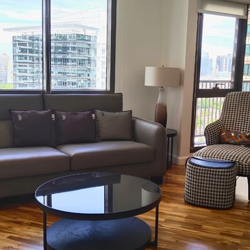 Modern living room with sofa and city view.