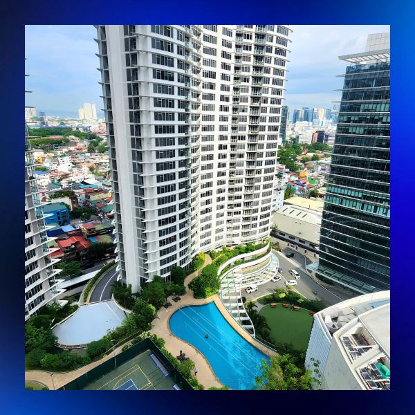 High-rise buildings with swimming pool and tennis court in a city.